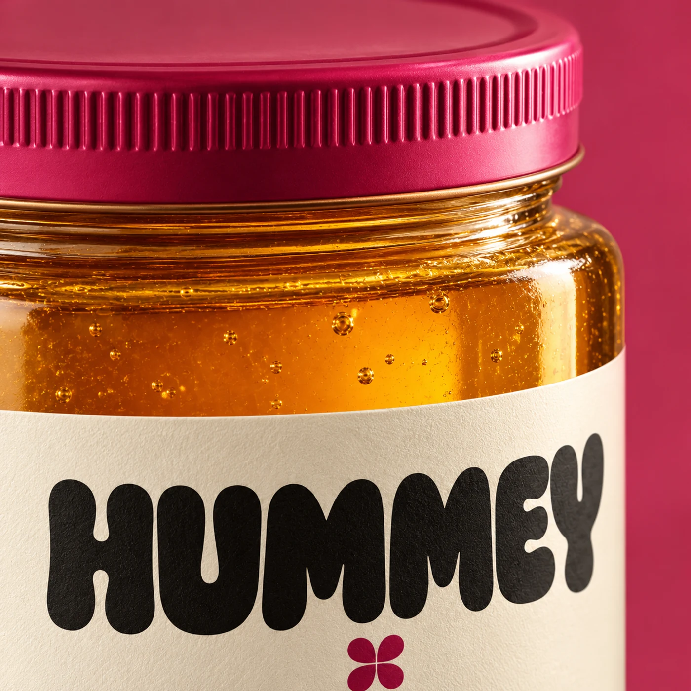 Three-quarter macro view of the Wildflower jar’s ribbed lid, glass, honey and paper label