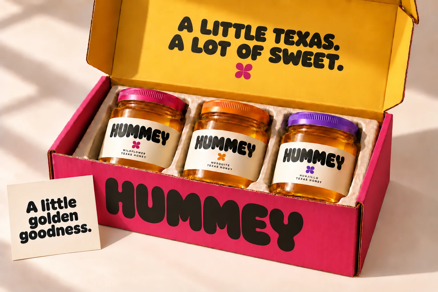 Three HUMMEY honey jars in a pink and golden gift box